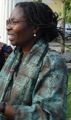 Portrait of Remi Omodele, Founder of My Palace Initiative, wearing patterned green and blue cloth.